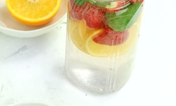 strawberries and orange slices with infused water on display.