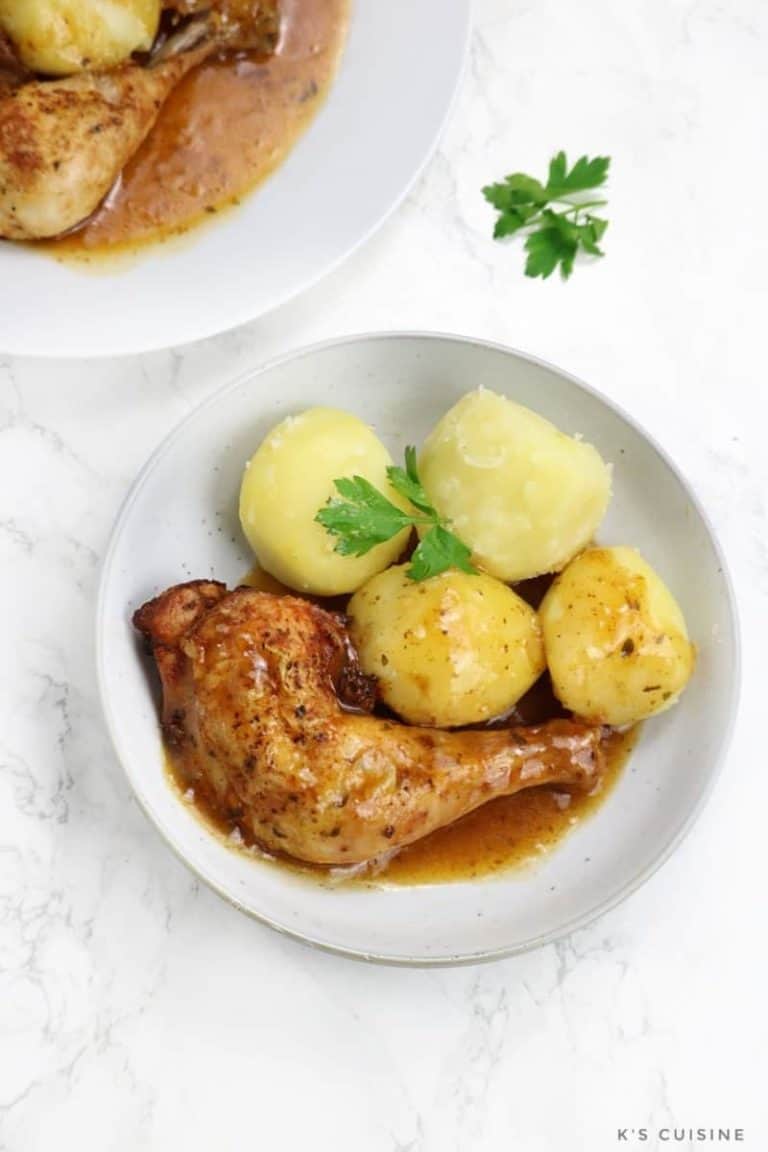 chicken leg served with gravy and potatoes.